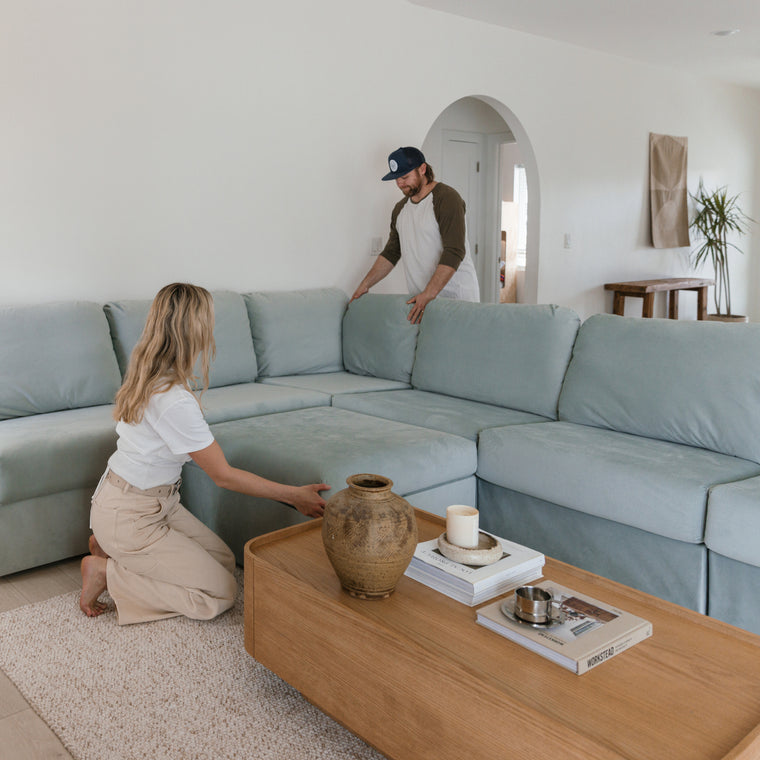 Couple assembling a Home Reserve sectional inside their living room